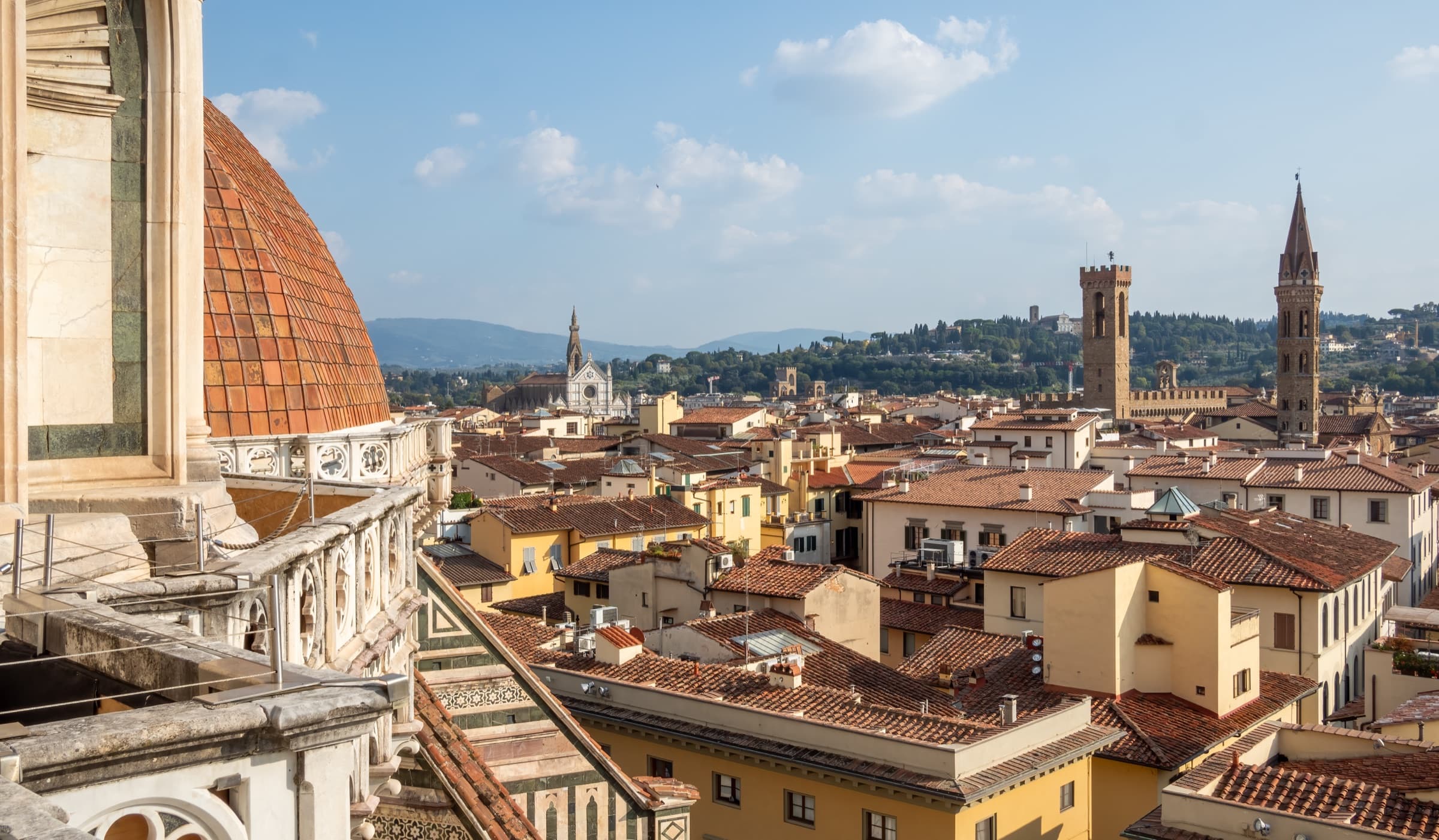 View of Florence rooftops from the Duomo terrace at golden hour