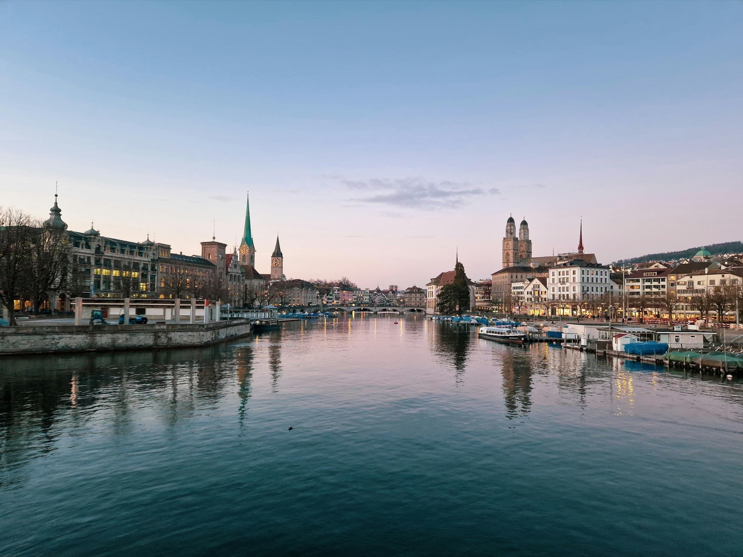 Limmat river at dusk with the spires of Zurich's old town